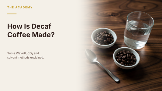 The Academy hero: How Is Decaf Coffee Made? — coffee beans and water on a wooden table