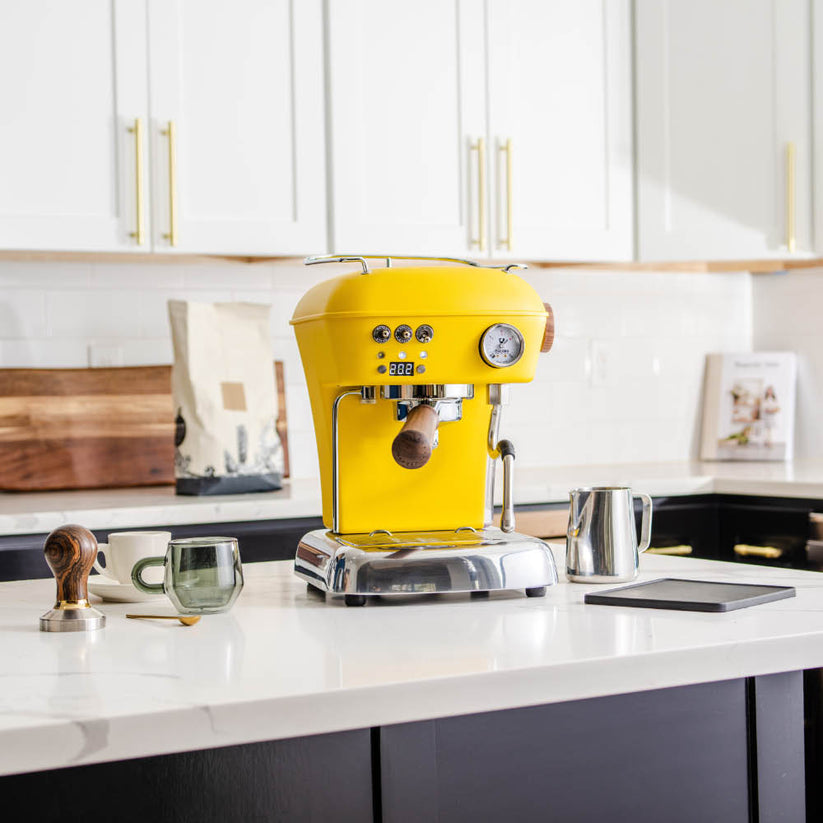 Ascaso Dream PID Sun Yellow Espresso Machine in a kitchen setup